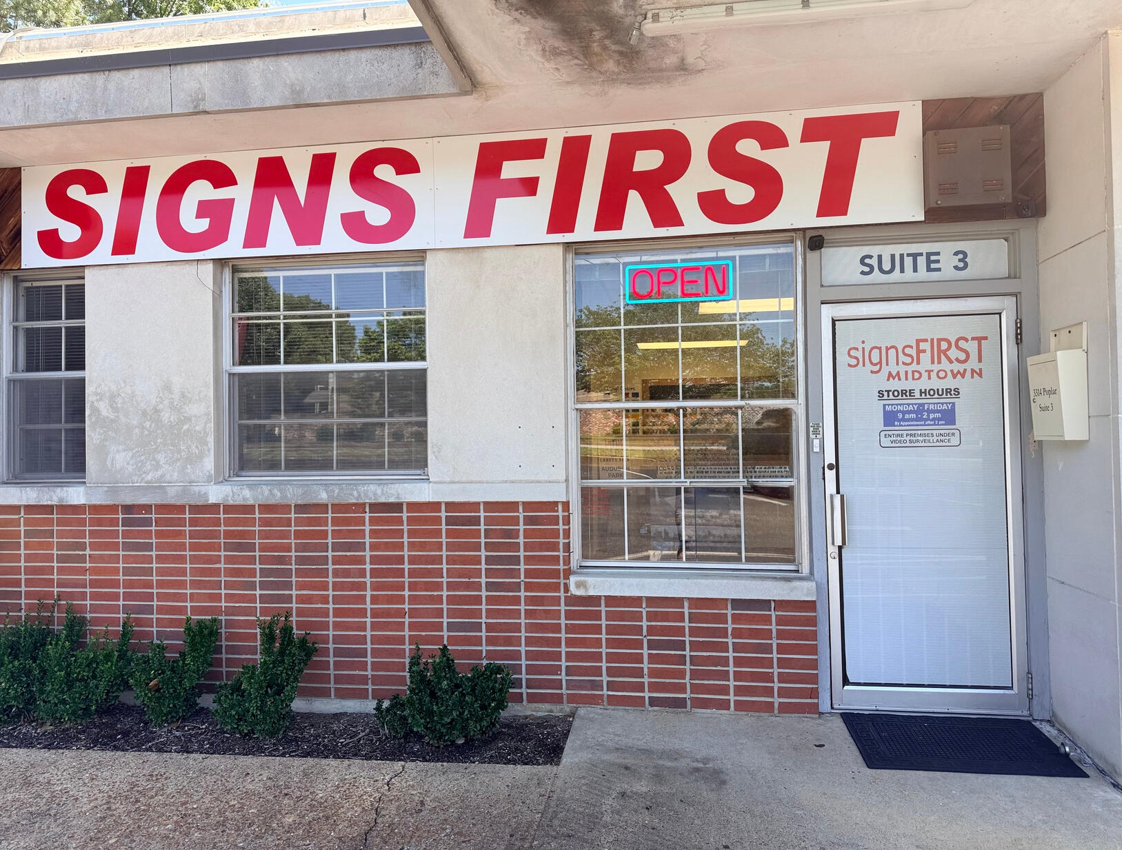 Full storefront of Signs First Midtown at 3314 Poplar Avenue, Suite 3, including the entrance and mailbox